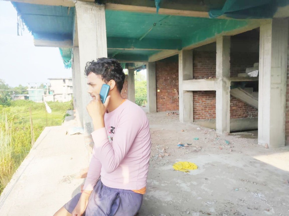 A migrant labourer working in the construction sector in Dimapur is seen speaking to his family in Bihar over phone on October 8. From handwritten letters read aloud to mobile phones, the power of technology has bridged the gap between miles and brought people closer than ever before. (Morung Photo)